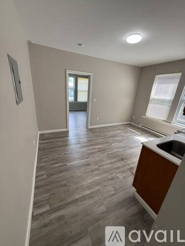 A room with a wooden floor and a window.