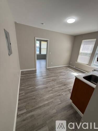 A room with a wooden floor and a window.