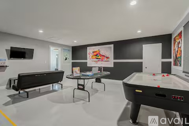 A room with a pool table and a bench.