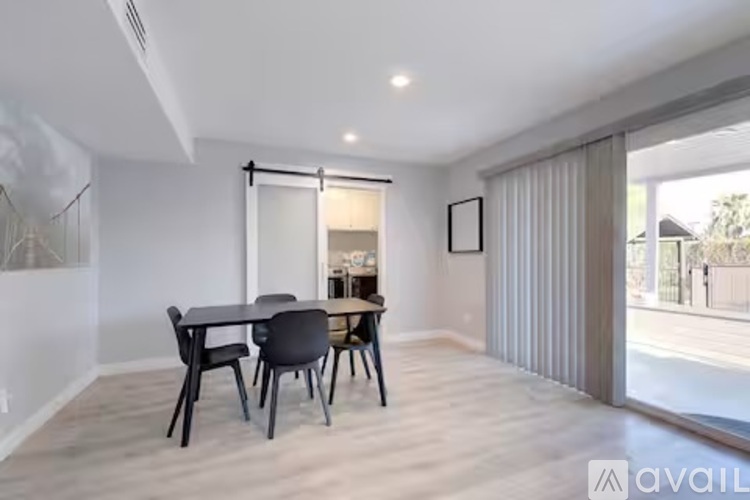 A dining room with a table and chairs.