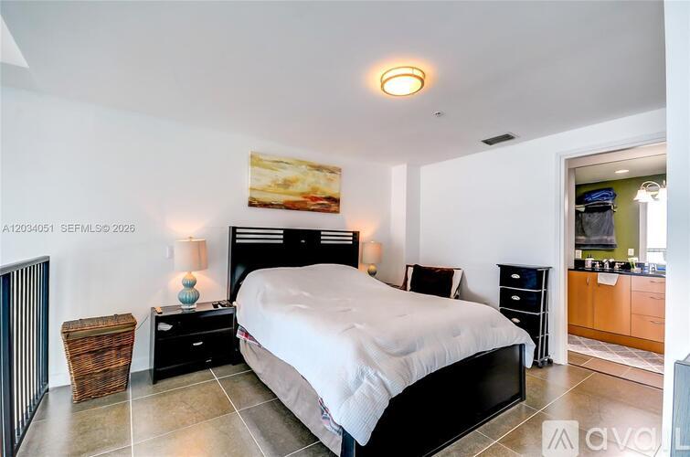 A bedroom with a large bed, nightstands, and a basket on the floor.