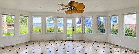 A room with a ceiling fan and a checkered floor.