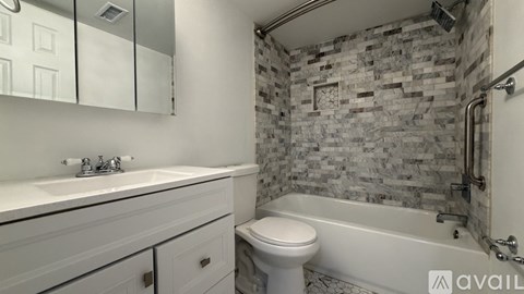 A bathroom with a stone wall and a white toilet.
