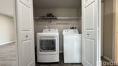 A small kitchen with a white oven and a white fridge.