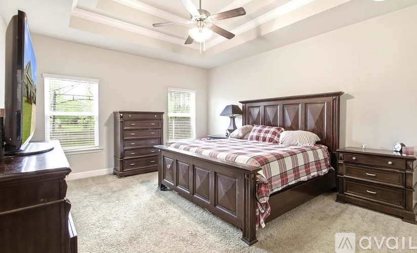 A bedroom with a large bed and a dresser.