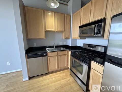 A kitchen with wooden cabinets and stainless steel appliances.