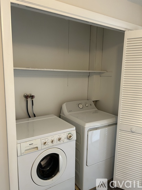 A small laundry room with a washer and dryer.