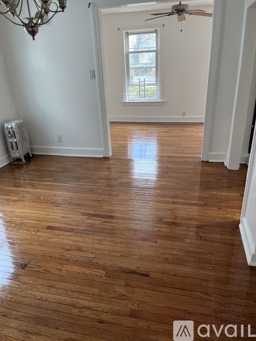 A room with wooden floors and a chandelier.