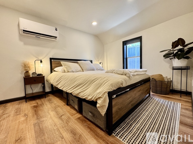 A bedroom with a large bed and a window.