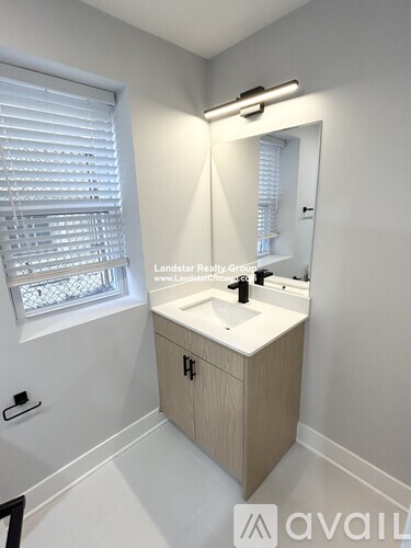 A bathroom with a sink and a mirror.