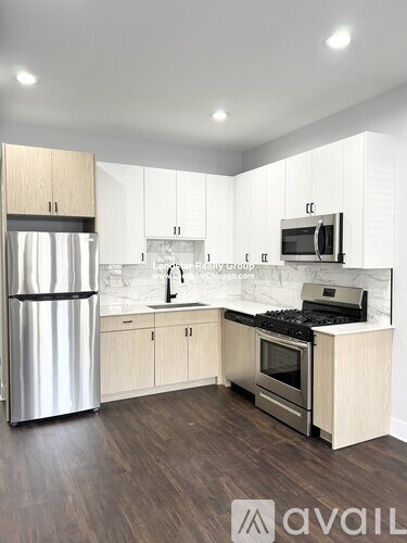 A modern kitchen with wooden cabinets and stainless steel appliances.