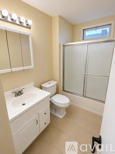 A bathroom with a sink, toilet, and shower.