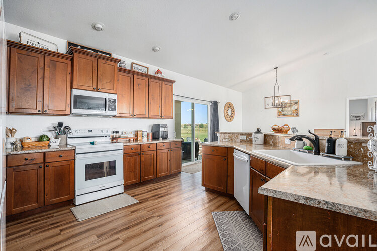 A kitchen with wooden cabinets and a white stove top oven.