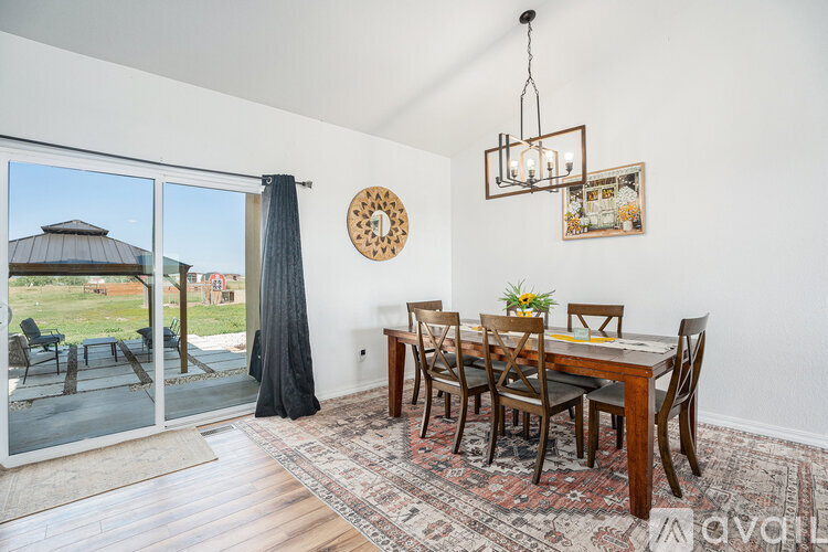 A dining room with a table set for four.