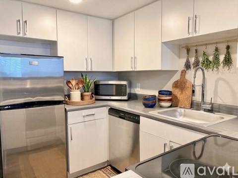 A kitchen with white cabinets and stainless steel appliances.