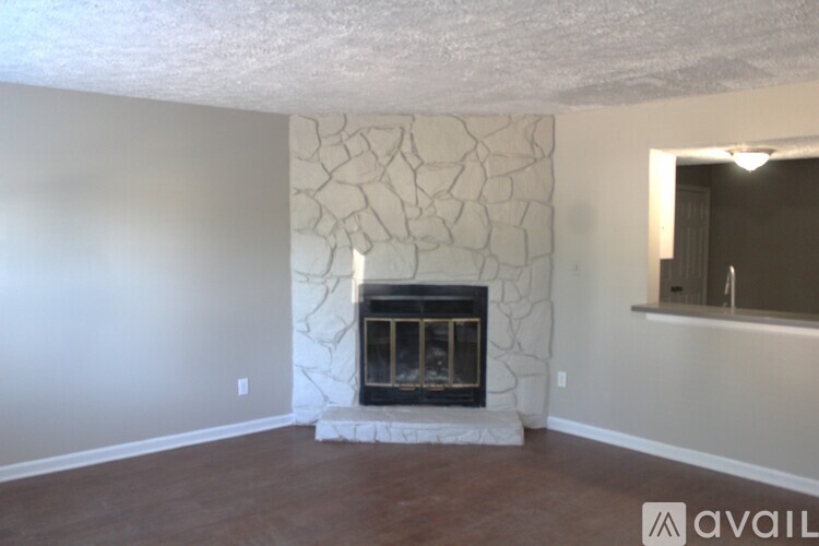 A room with a fireplace and a marble wall.