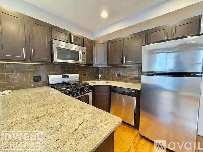 A kitchen with granite countertops and stainless steel appliances.