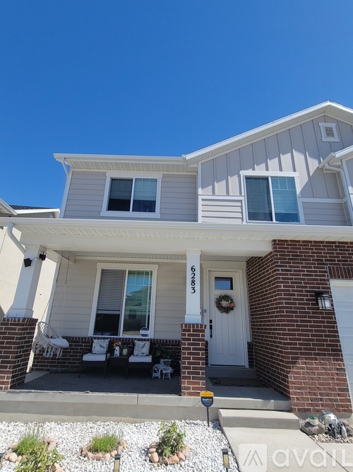 A house with a white door and a garage door.