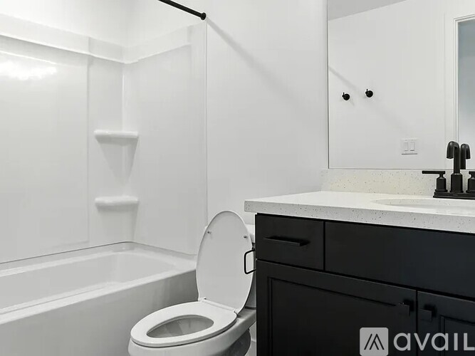A bathroom with a toilet, sink, and bathtub.
