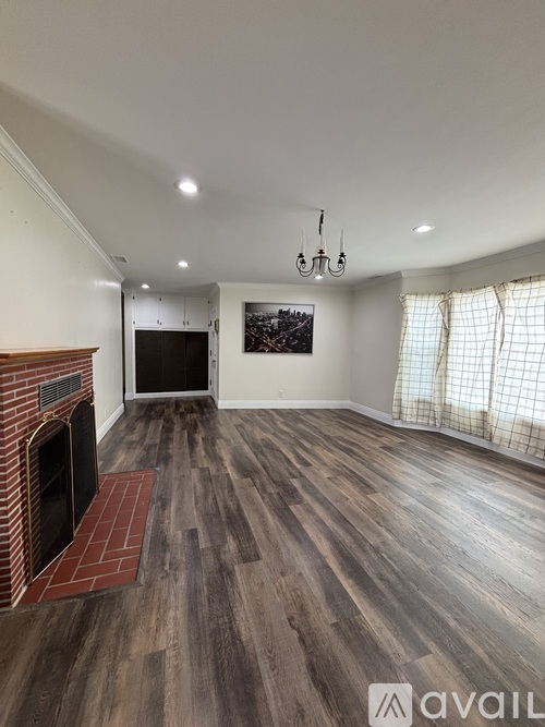 A living room with a fireplace and a painting on the wall.