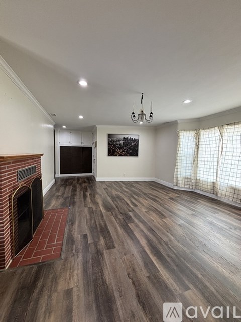 A living room with a fireplace and a painting on the wall.