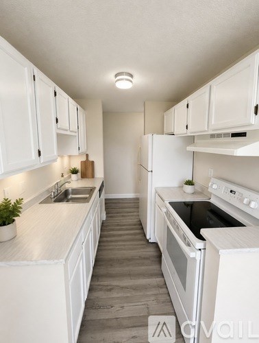 A white kitchen with a sink and oven.