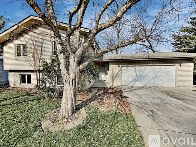 A house with a tree in front of it.