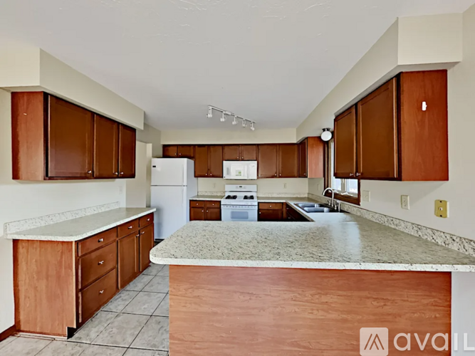 A kitchen with brown cabinets and a white countertop.