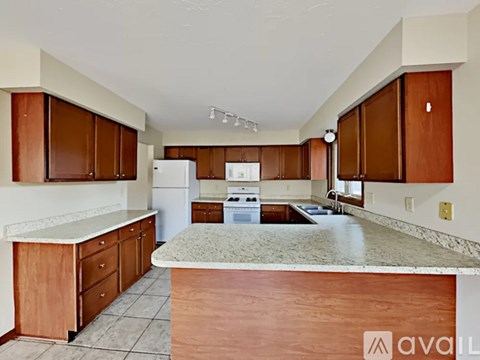 A kitchen with brown cabinets and a white countertop.