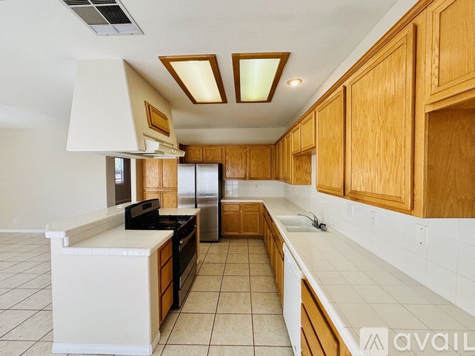 A kitchen with wooden cabinets and a white countertop.