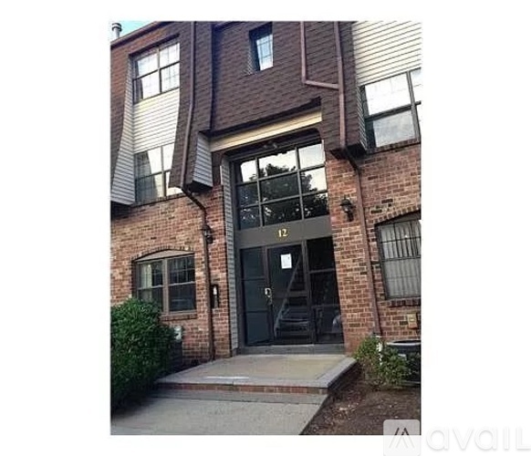 A brick building with a black door and windows.