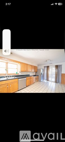 A kitchen with wooden cabinets and a tiled floor.