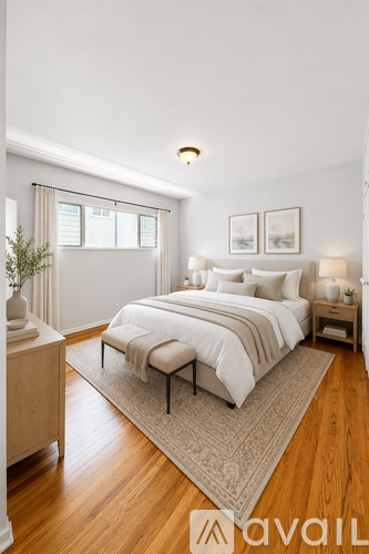A bedroom with a large bed and a wooden floor.