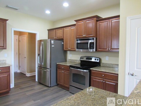 A kitchen with wooden cabinets and stainless steel appliances.