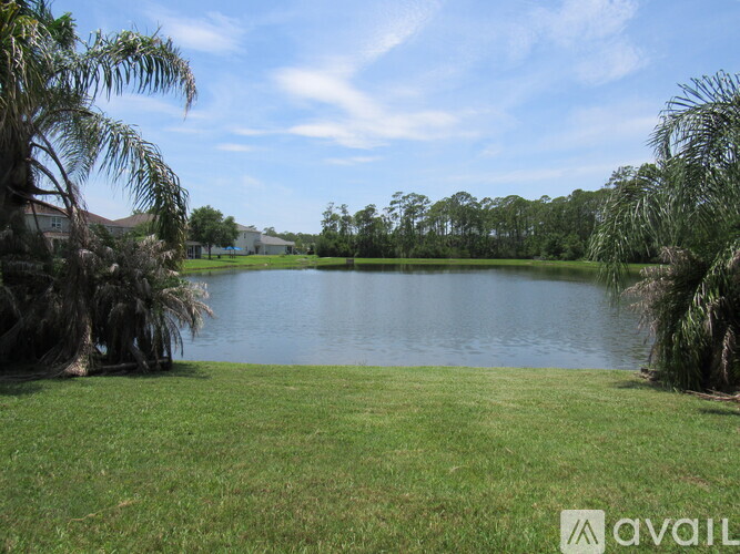 A large body of water surrounded by greenery and trees.