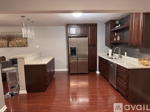 A kitchen with brown cabinets and a refrigerator.