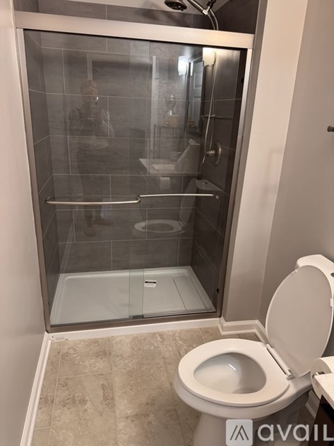 A bathroom with a toilet and a walk-in shower.