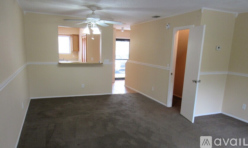 A room with a ceiling fan and a window.