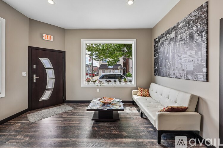 A living room with a couch, coffee table, and a large window.
