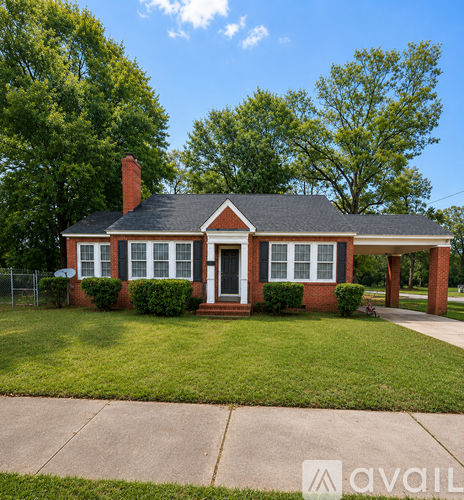 A house with a red brick exterior and a black roof.