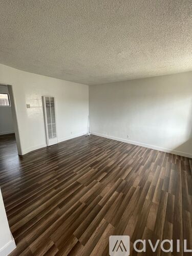 A room with wooden flooring and a window.