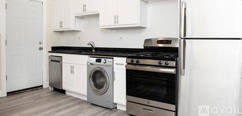 A modern kitchen with a stainless steel oven and refrigerator.