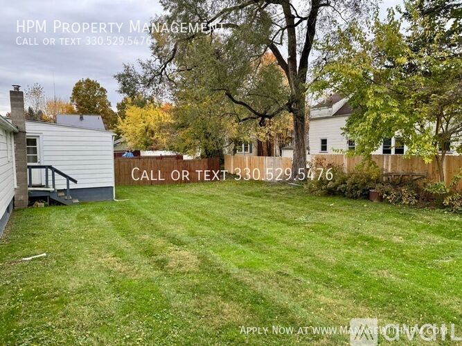 A yard with a sign that says "Call or text 330.529.5776".