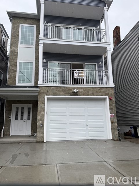 A two-story house with a white garage door.