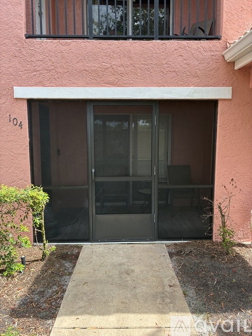 A pink building with a number 104 on the left side.