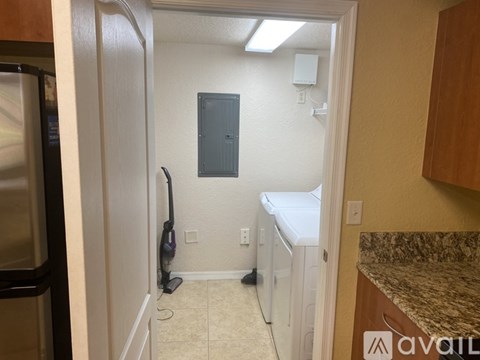 A kitchen with a white dishwasher and a white washing machine.
