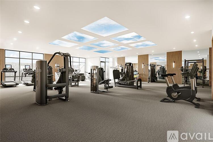 A gym with a variety of equipment including treadmills, weights, and exercise machines.