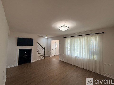 A kitchen with a white countertop and wooden flooring.