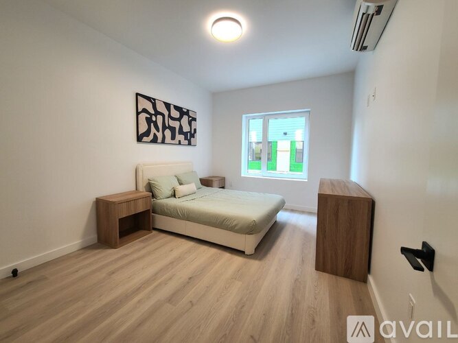 A bedroom with a bed, nightstand, and a wooden bench.