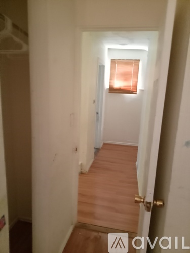A hallway with a door at the end.